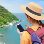 Budget-Friendly Trip Australian traveler using PocketSmith app on smartphone for budget-friendly trip planning.