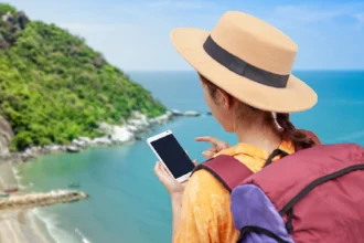 Budget-Friendly Trip Australian traveler using PocketSmith app on smartphone for budget-friendly trip planning.