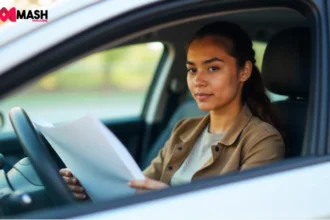Young driver reviewing comprehensive car insurance policy while seated in their vehicle